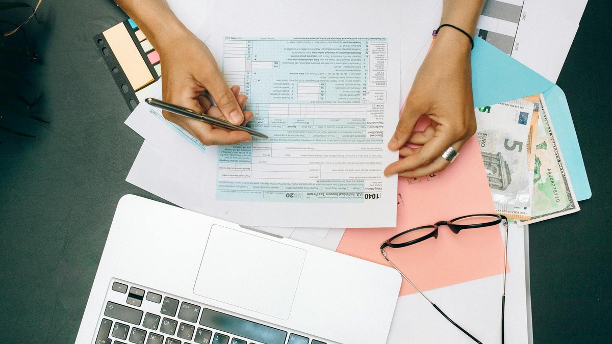 korean office worker calculating taxes on a desk with papers