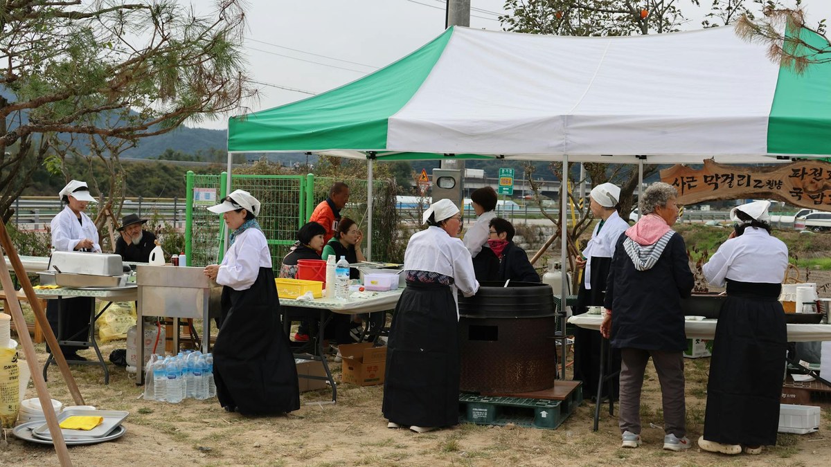 korean workers celebrating labor day with smiles and banners in a park