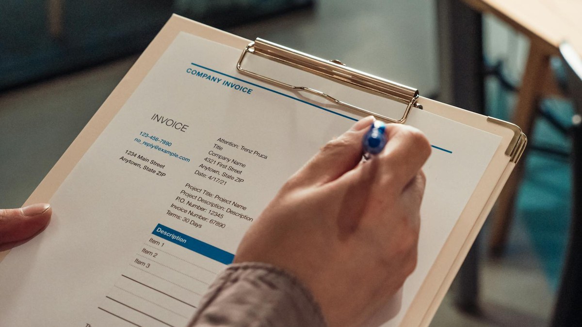 hand holding receipts and invoices, organized