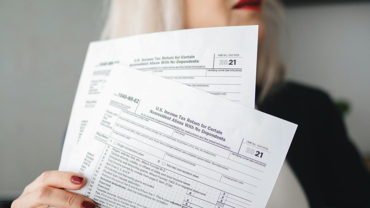 korean small business owner looking confused at tax forms