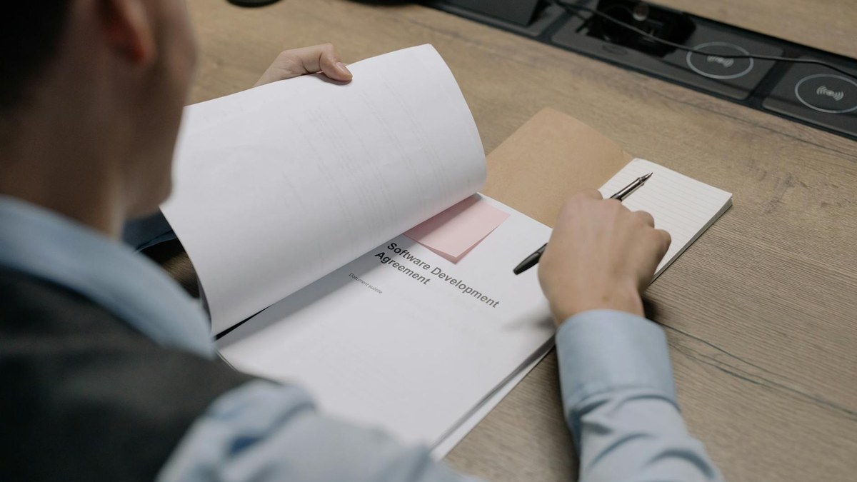 korean small business owner looking worried at a lease contract document