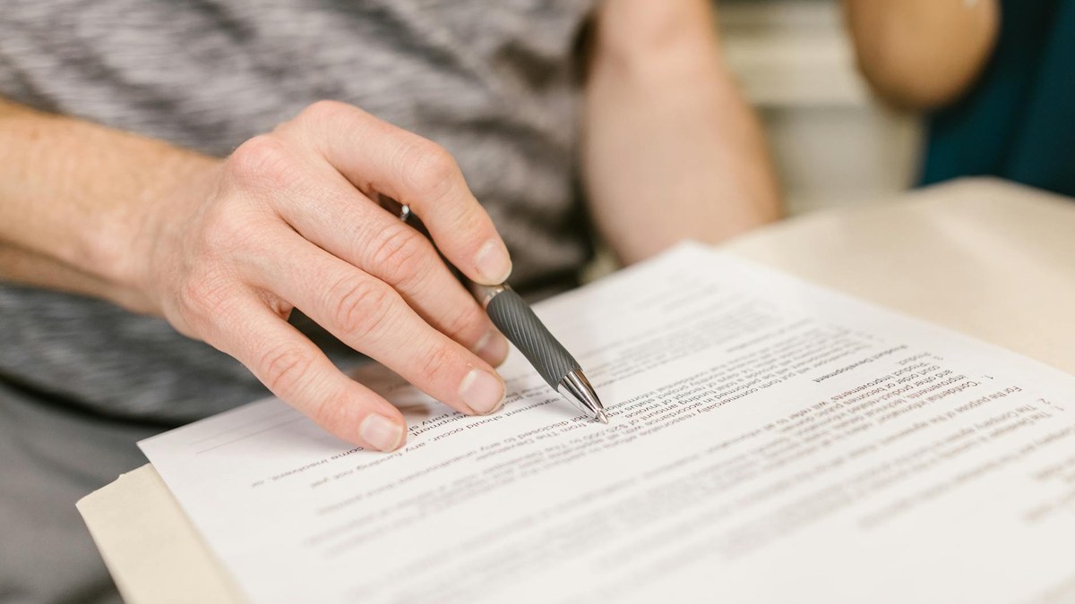 hand pointing to specific clause in a commercial lease contract