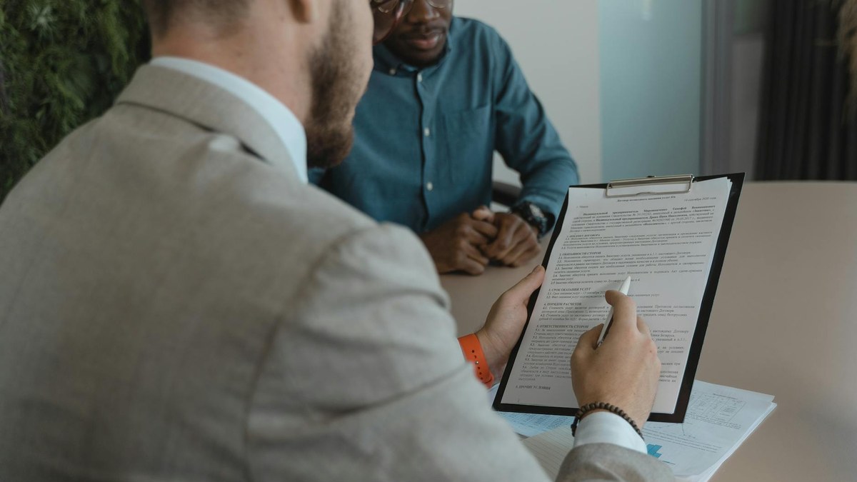 korean small business owner discussing employment contract with a part-time worker in a bright cafe