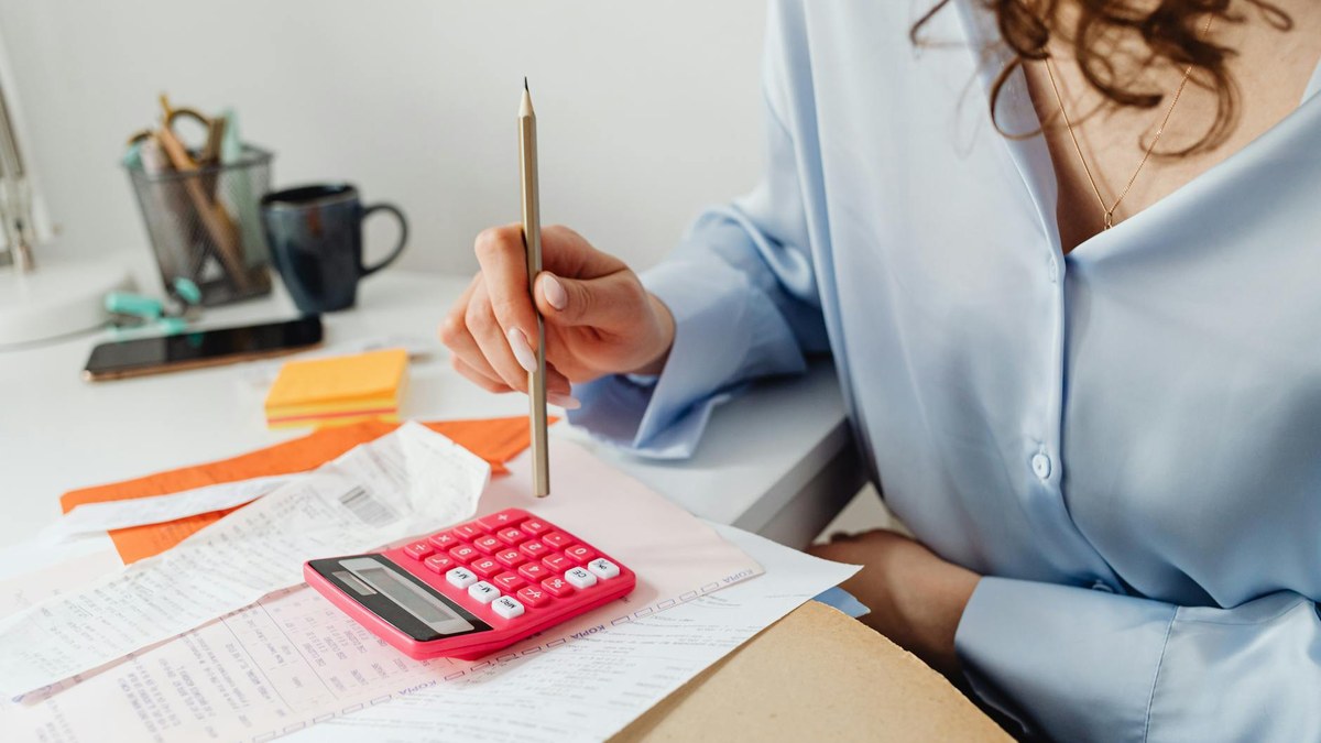 korean small business owner organizing receipts and invoices at a desk