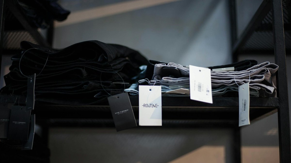Neatly organized shelves in a retail store's backroom with labels and clear inventory management signs