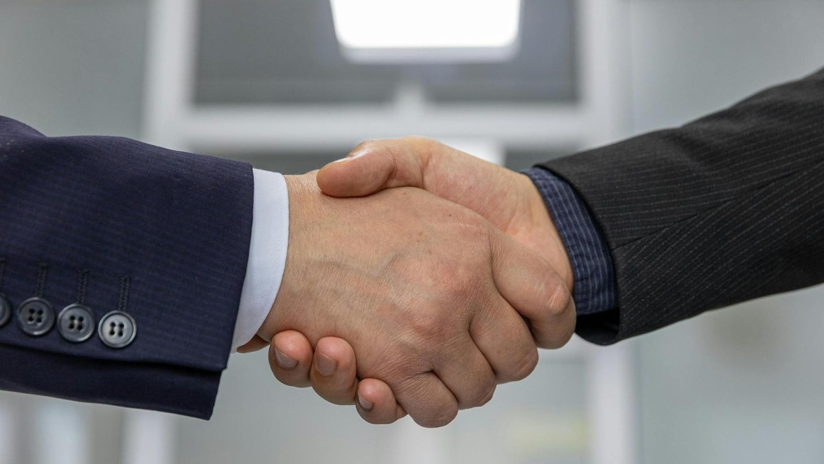 handshake between two people finalizing a business deal