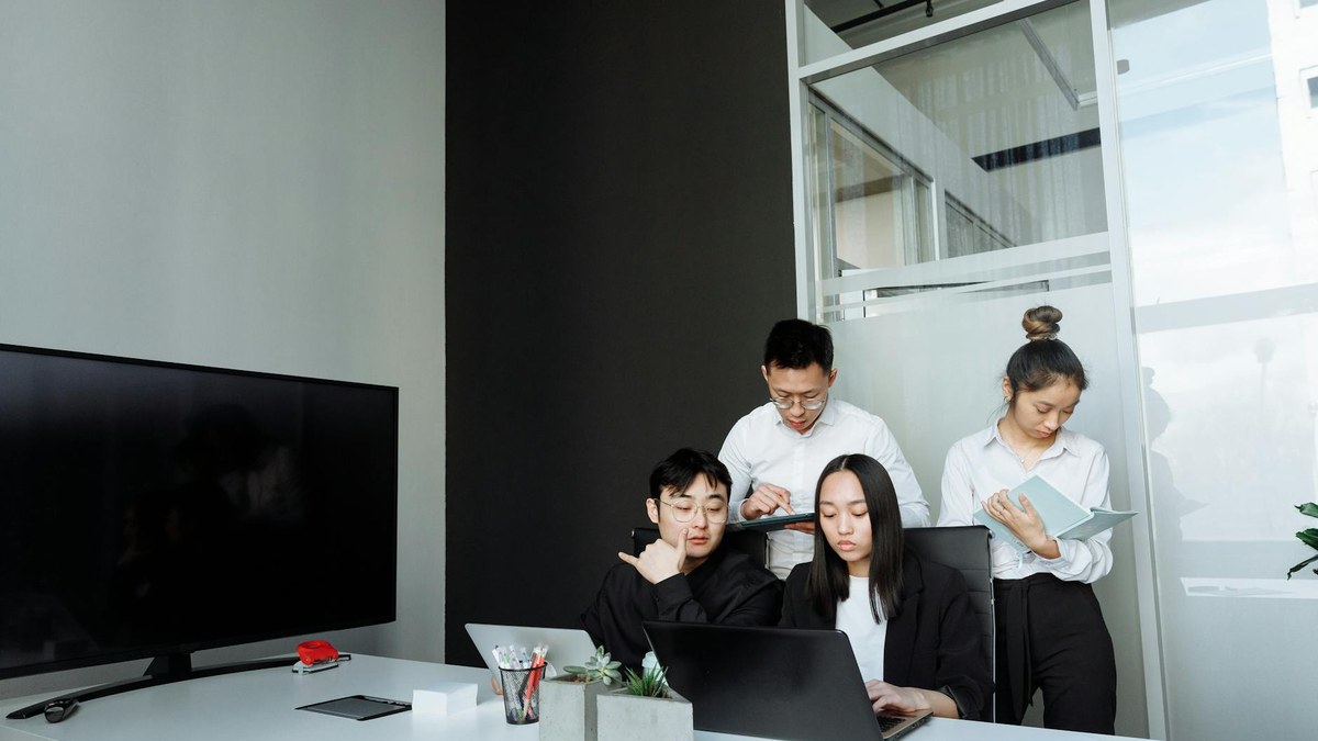 korean entrepreneur planning business on laptop in modern office