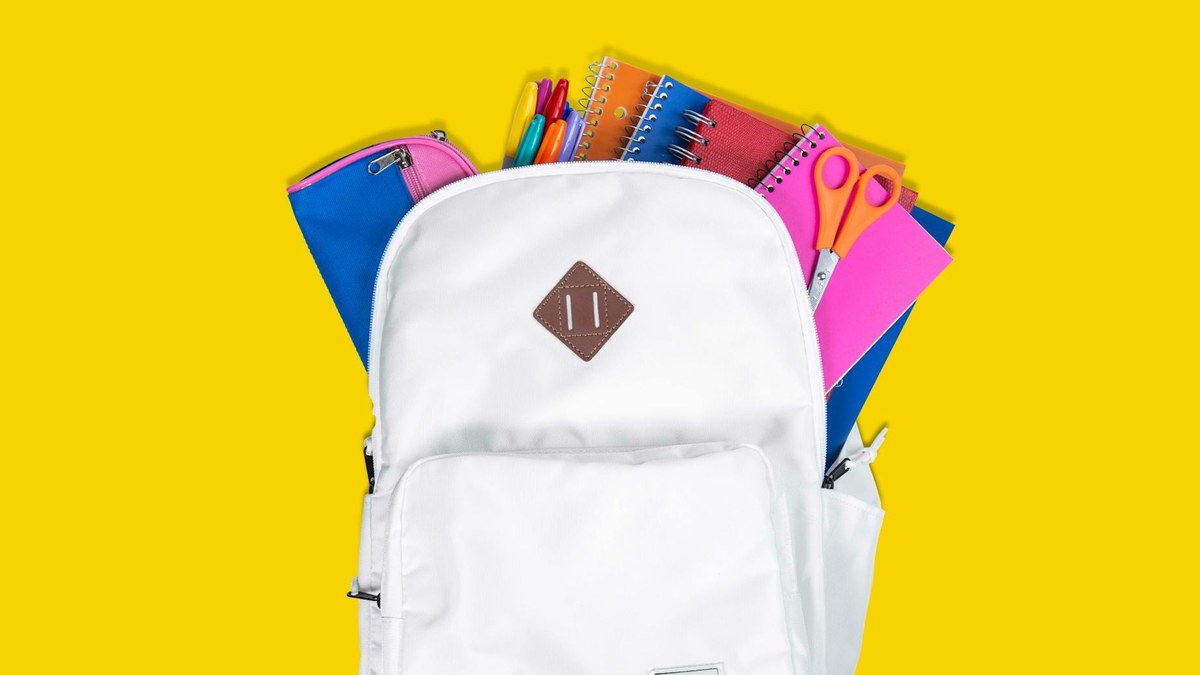 organized interior of a backpack with various gadgets and notebooks