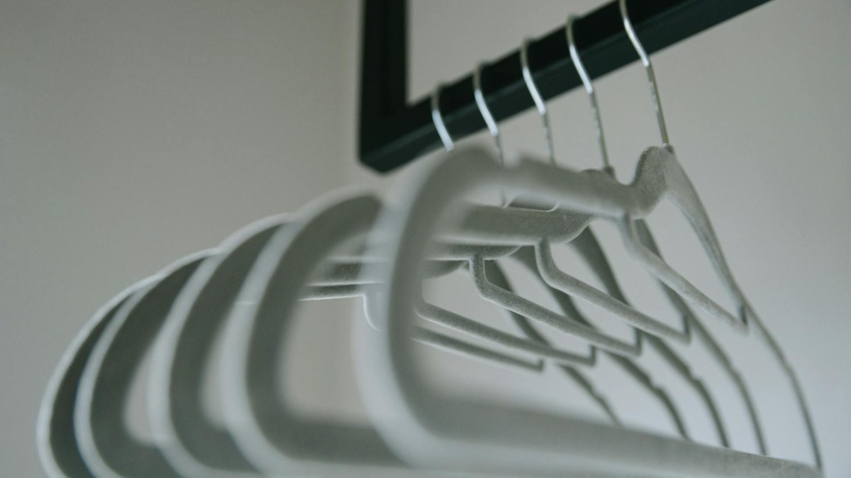 set of modern grey non-slip rotating hangers holding garments