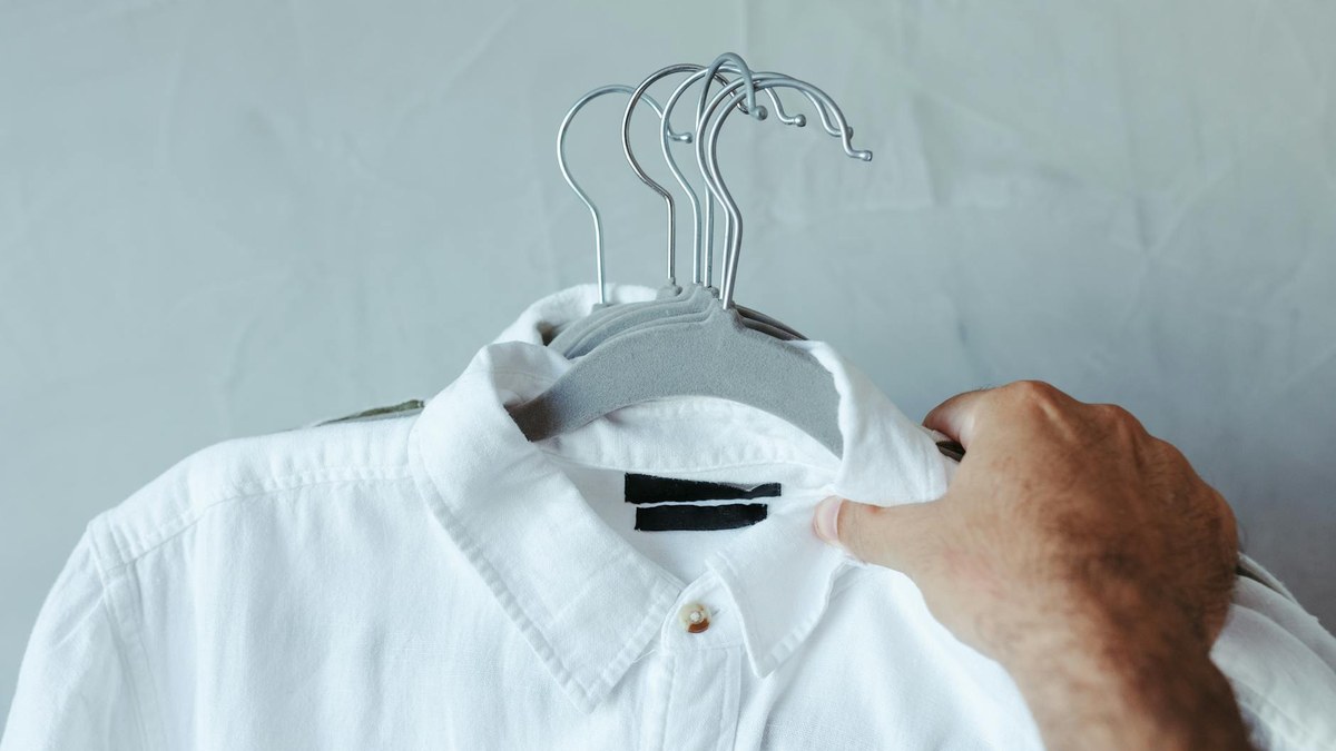 close up of a wrinkled shoulder area on a shirt caused by a standard hanger