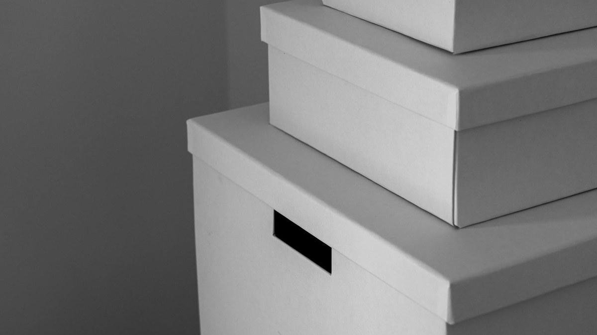 stack of grey square storage boxes in a modern living room