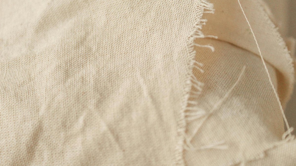 close-up of different fabric textures for summer shorts: cotton, linen blend, quick-dry synthetic