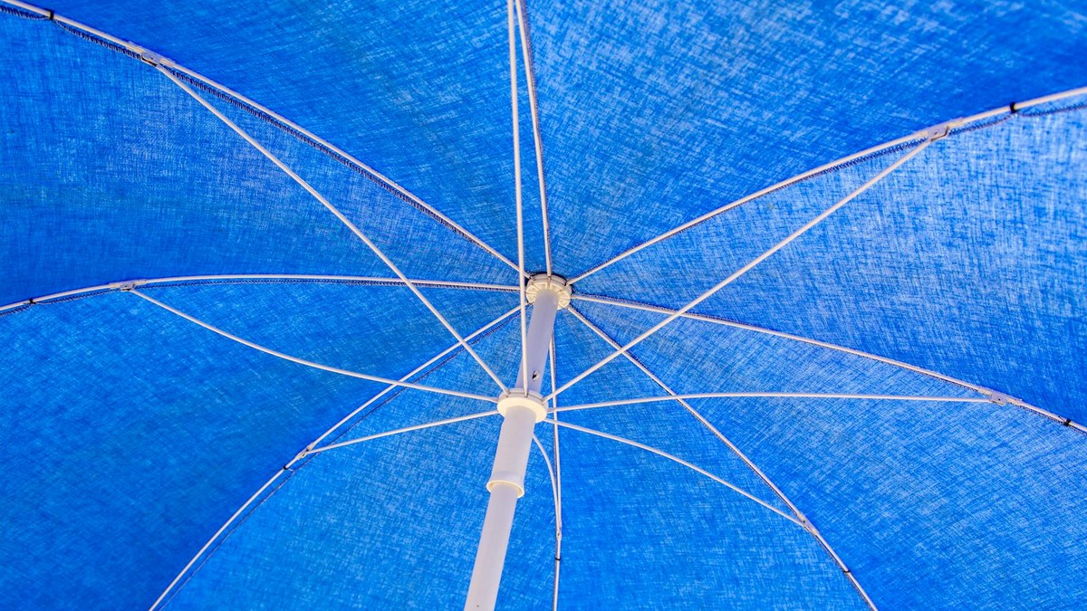 close-up of an umbrella's automatic open/close button and fabric texture