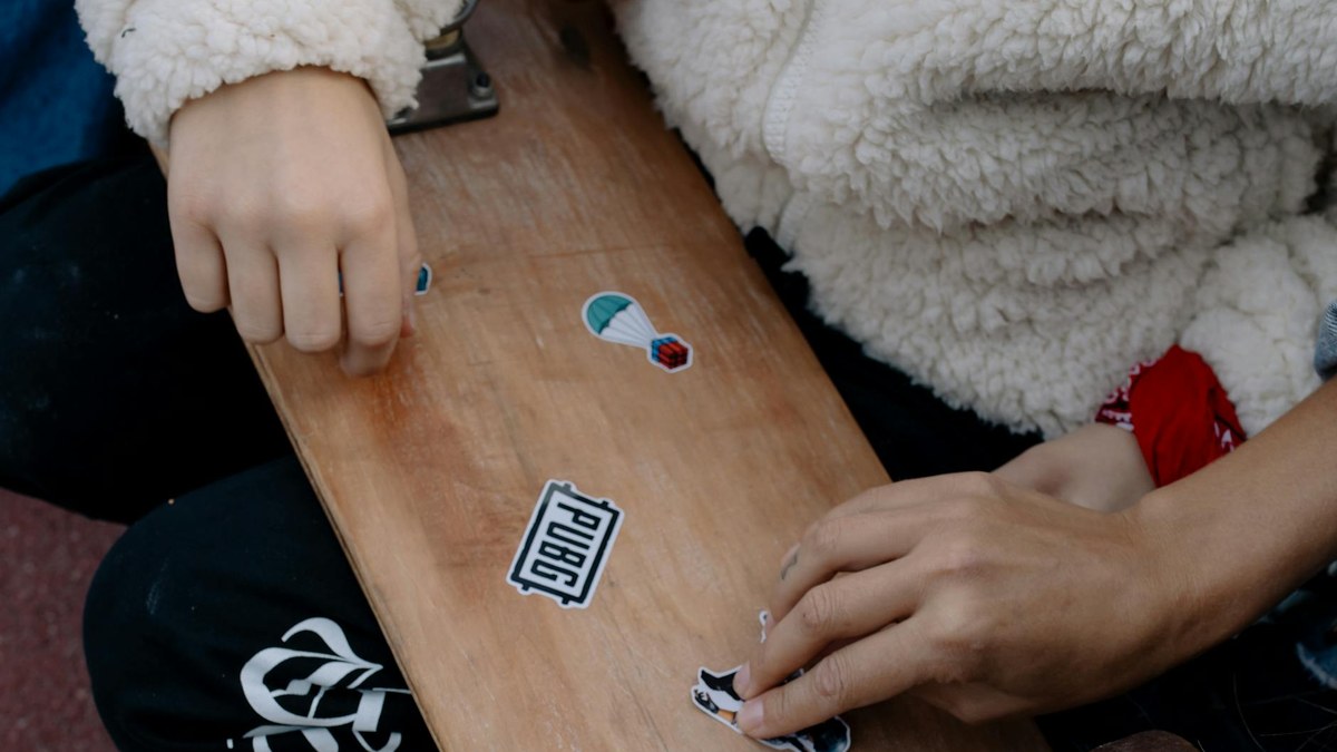 close-up of a modern one-touch water bottle with colorful stickers applied to it
