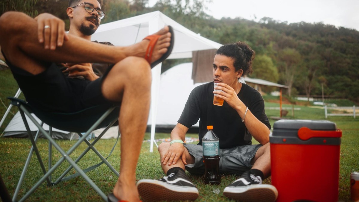 person comfortably sitting on a portable folding stool during an outdoor picnic