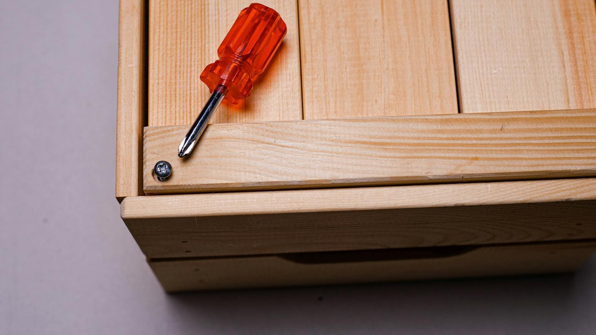 detailed close-up of a portable folding stool's sturdy hinge mechanism