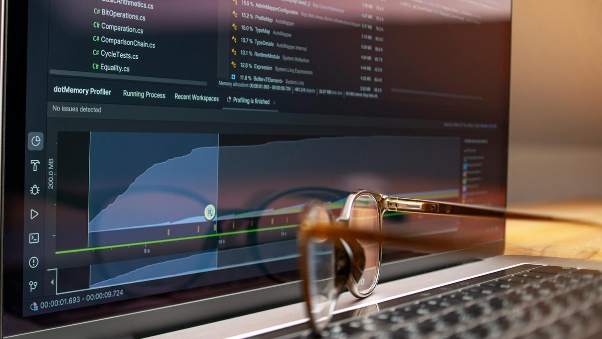 developer looking at performance graphs on a laptop screen