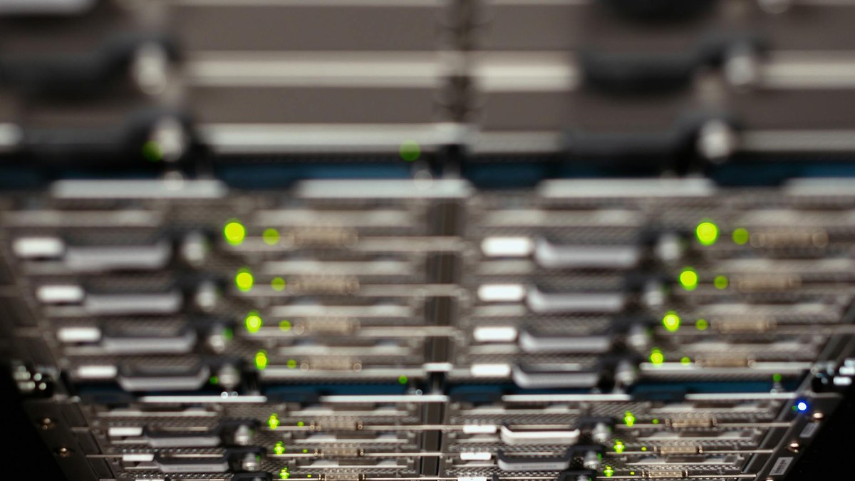 modern data center server room with blinking lights