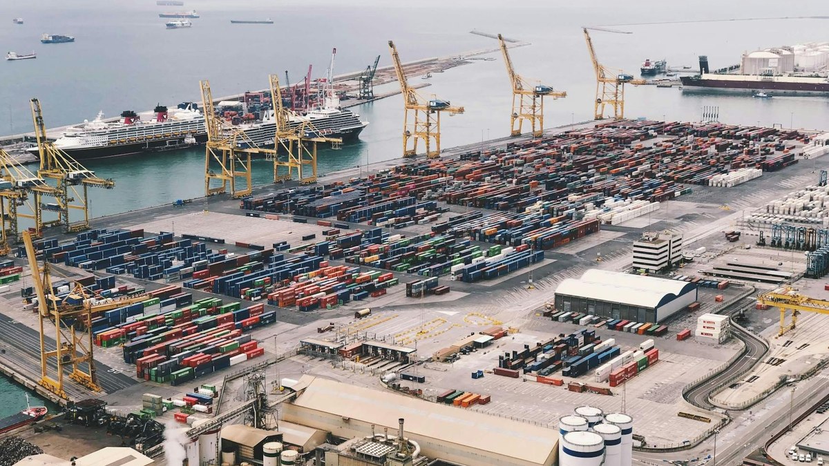 aerial view of a busy modern port with AGVs and 5G antennas