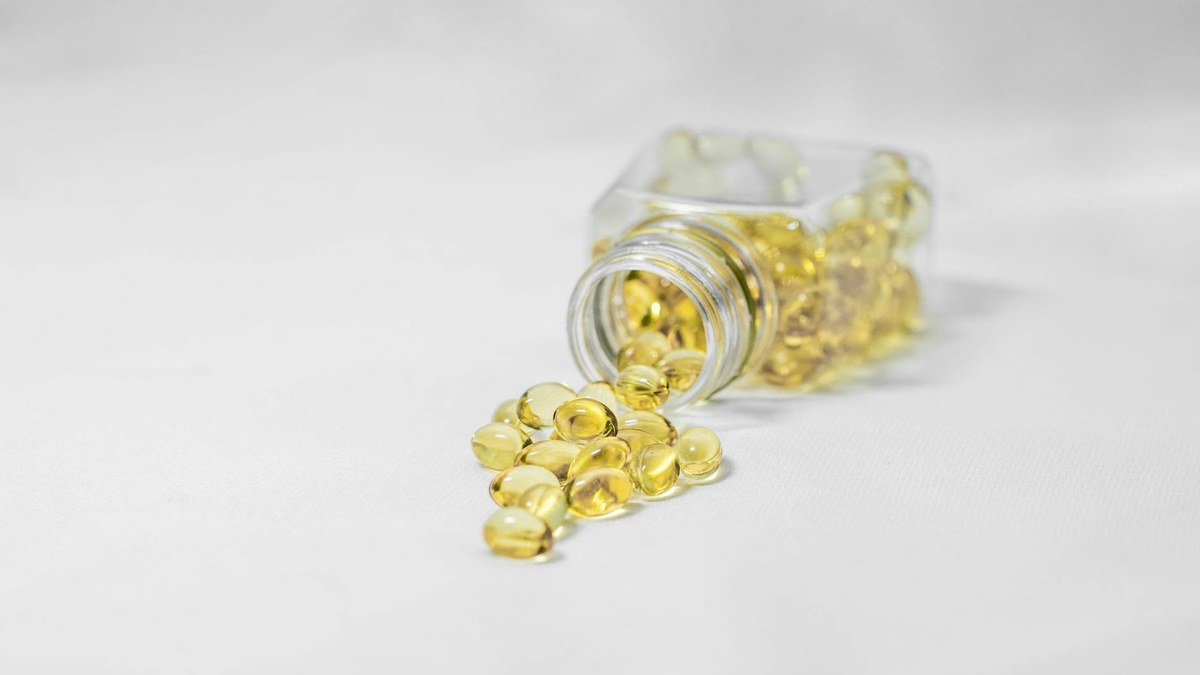 close-up of vitamin D supplement bottles on a clean white surface