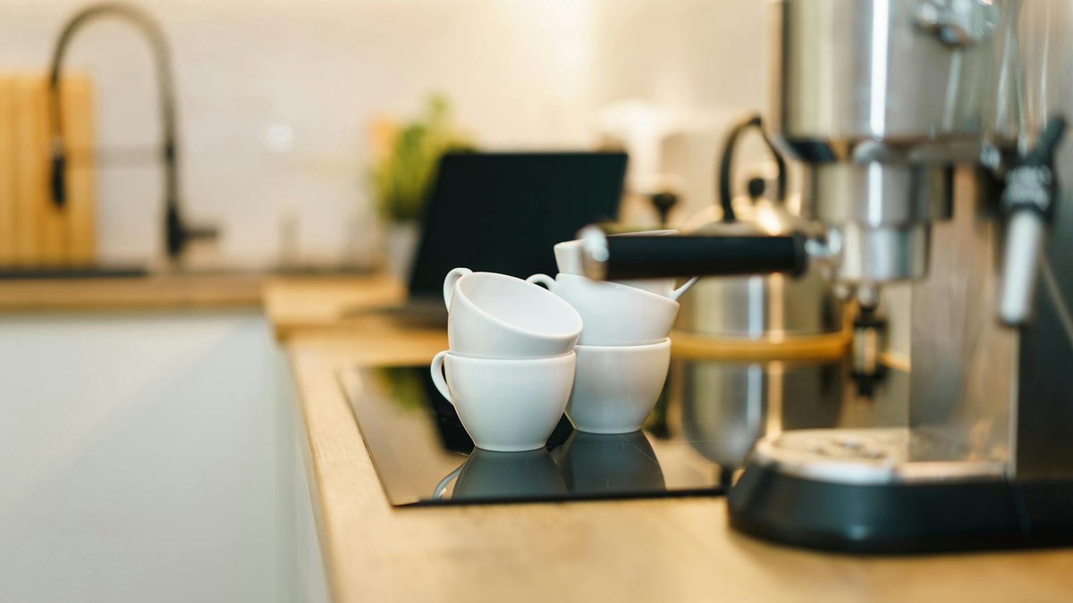 minimalist coffee station with espresso machine and ceramic mugs