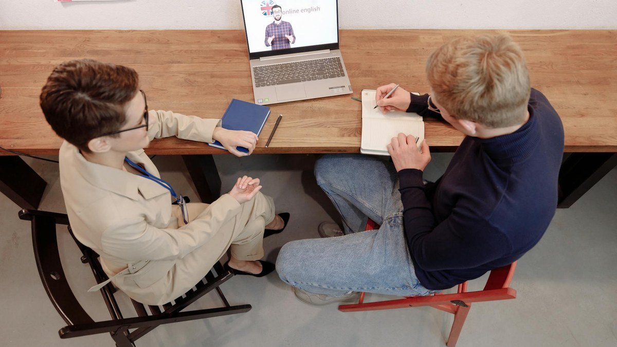 person having an online english conversation with an AI tutor on a laptop