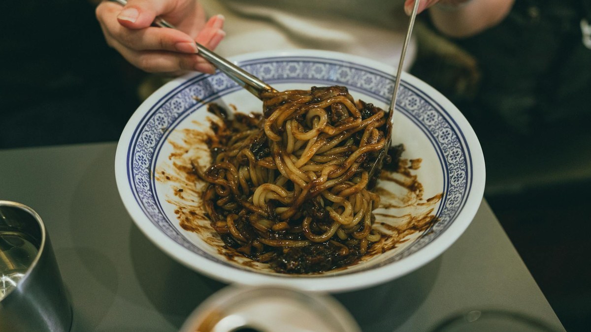 woman enjoying a simple, delicious korean meal at a small local restaurant