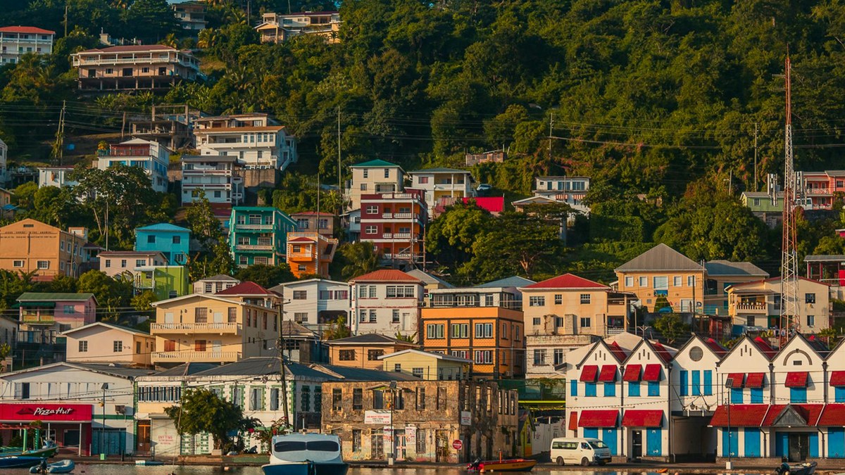 colorful houses lining a hillside overlooking a fishing port