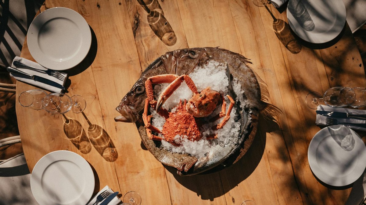 fresh seafood platter displayed on a wooden table by the sea