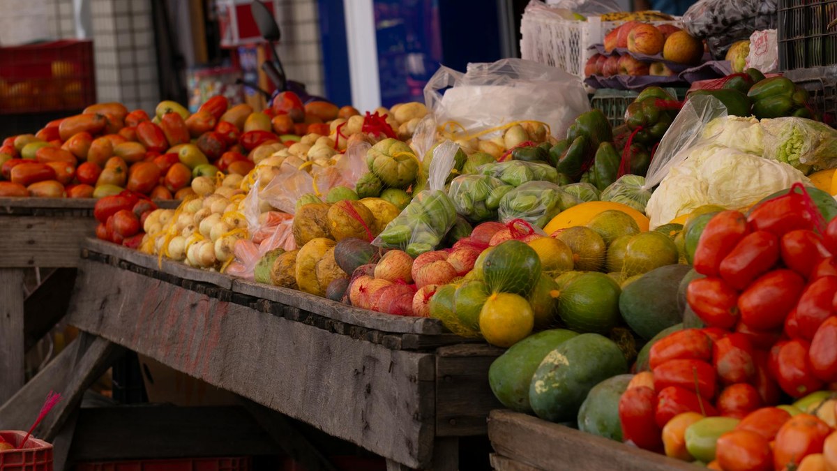 traditional korean market stall selling fresh fruits and vegetables with local vendors