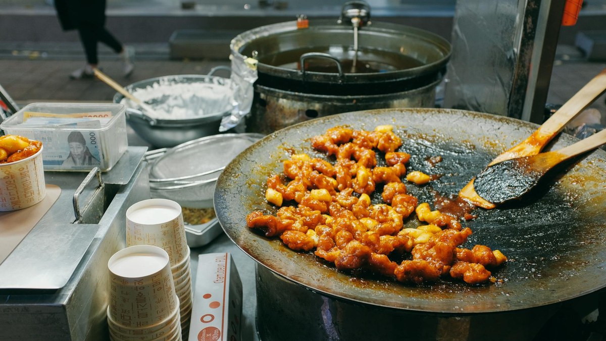 Andong Jjimdak in a traditional Korean market stall, steaming hot chicken dish
