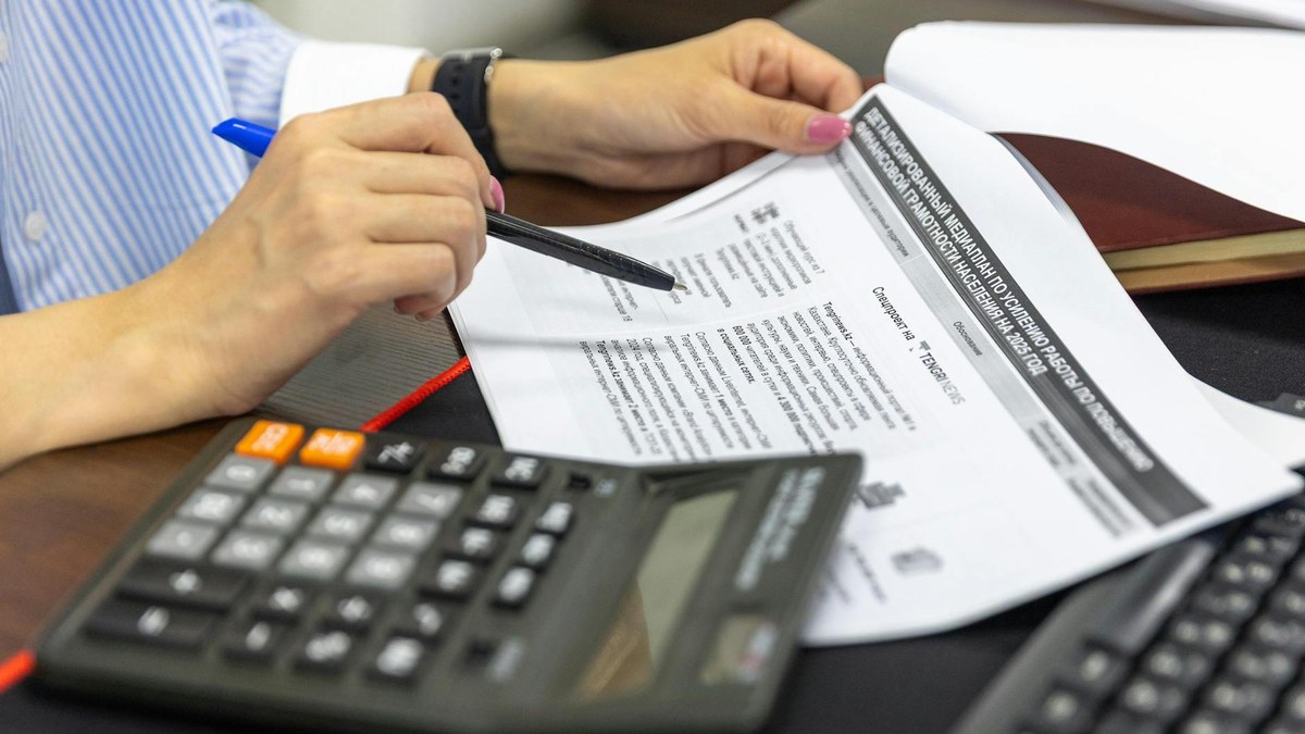 korean woman reviewing financial documents at a bright desk