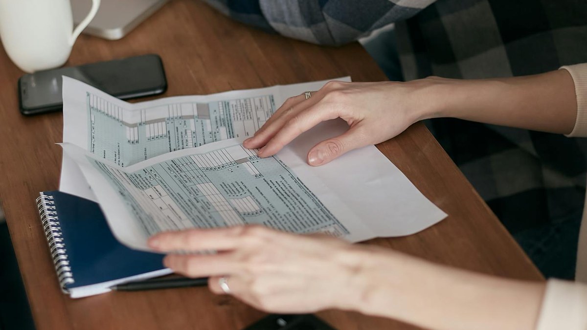 korean freelancer working on laptop with tax documents