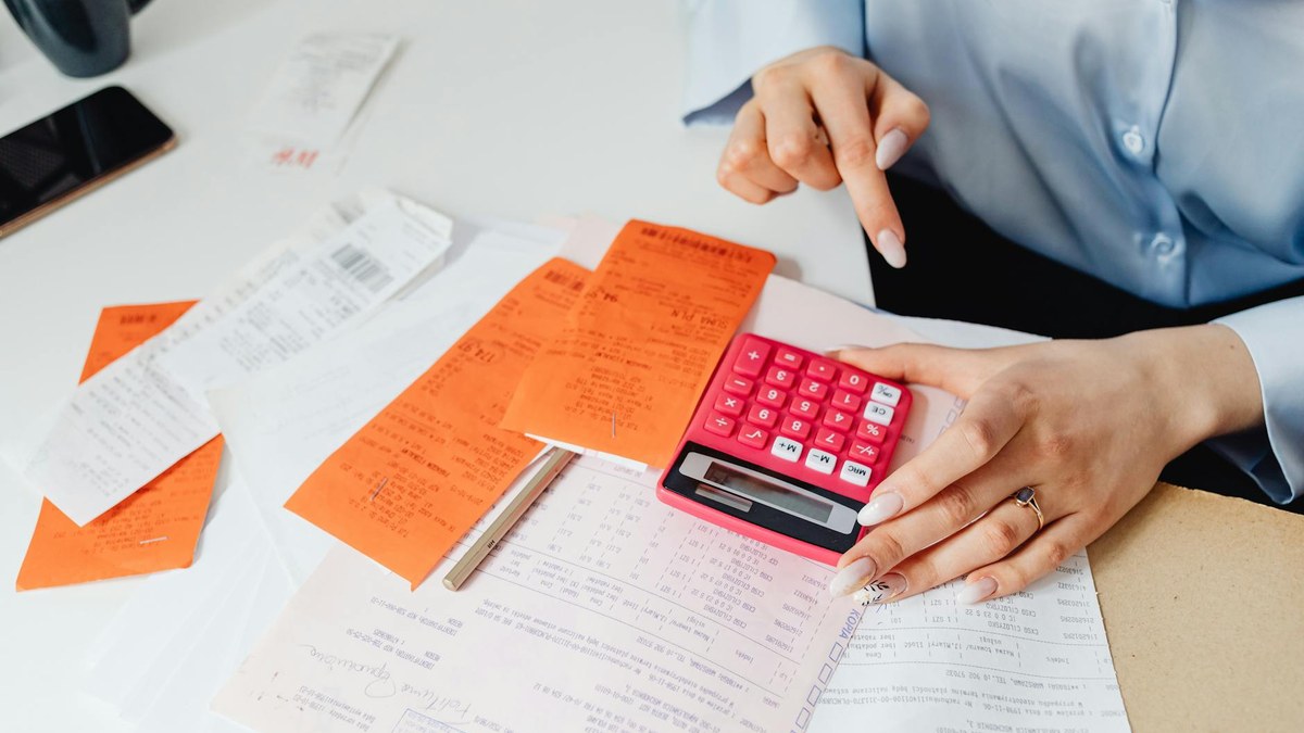 stack of receipts and a calculator on a desk