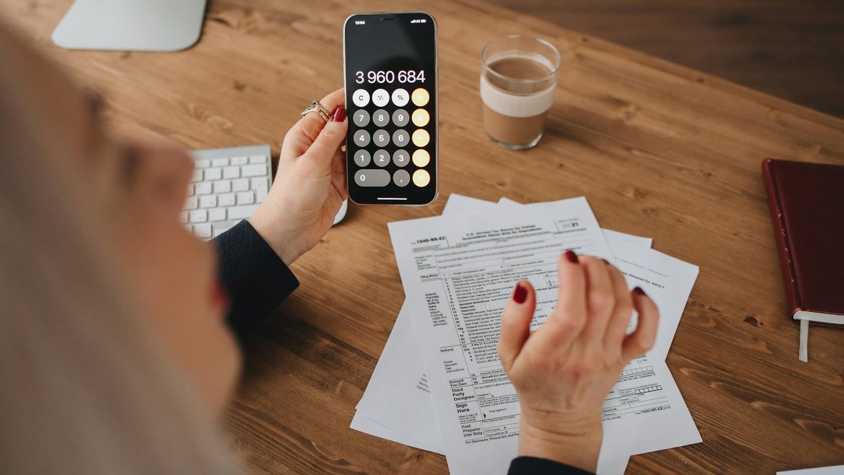 modern office desk with calculator, notepad, and coffee, symbolizing financial planning