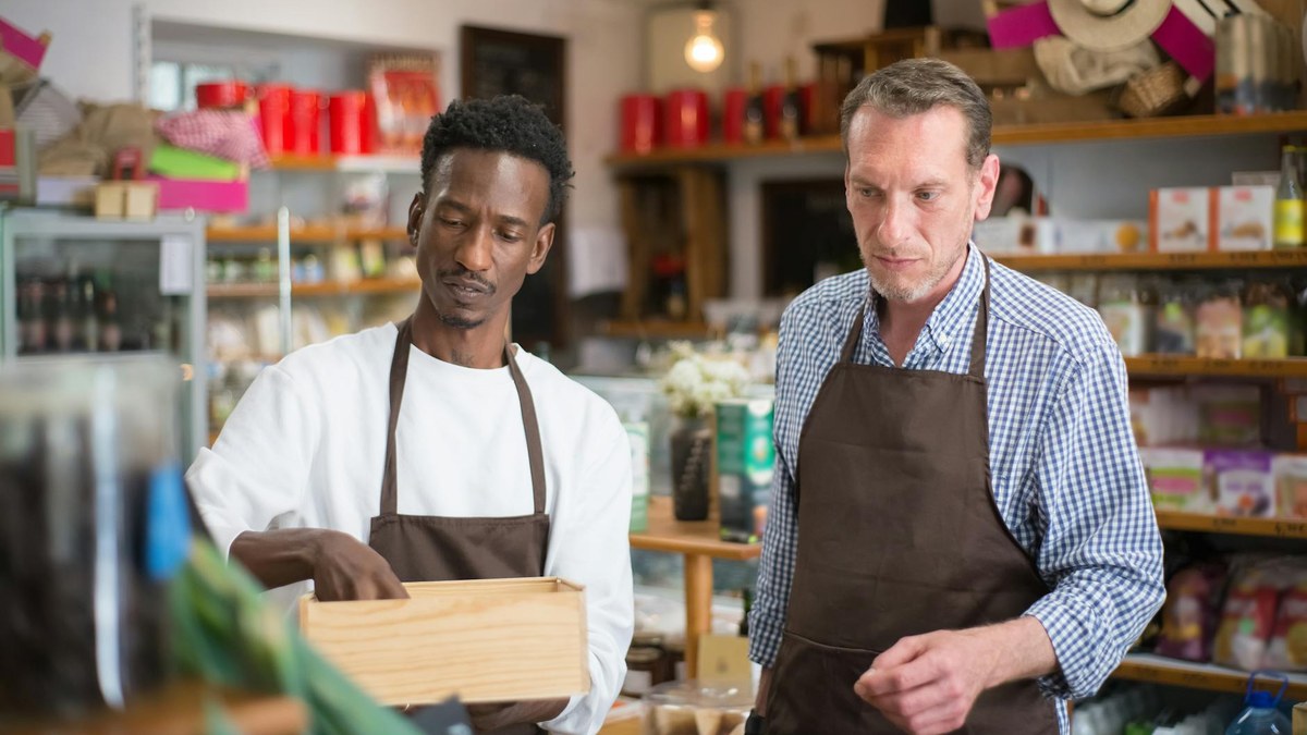 small business owner checking fire extinguisher in a shop