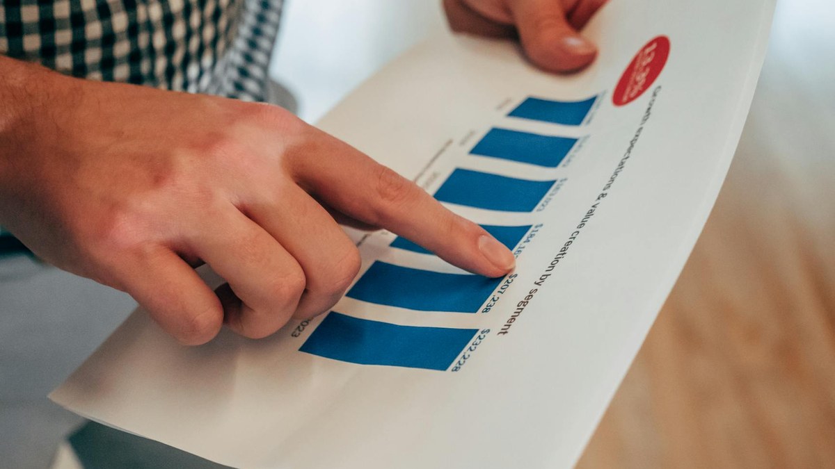 a small business owner and an influencer reviewing a campaign performance report together