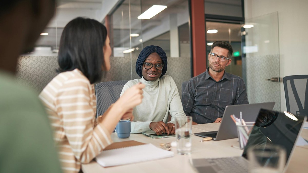 a diverse group of small business owners attending a workshop, collaborating and taking notes