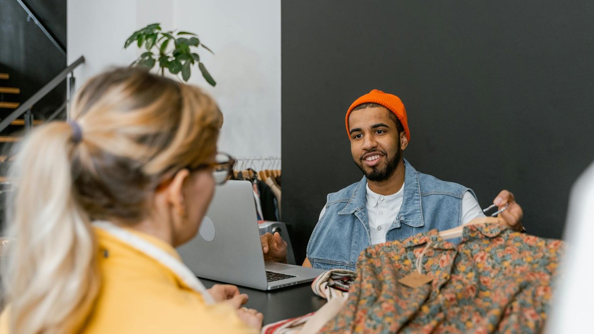 a small retail shop interior with a few customers browsing, clean and modern design