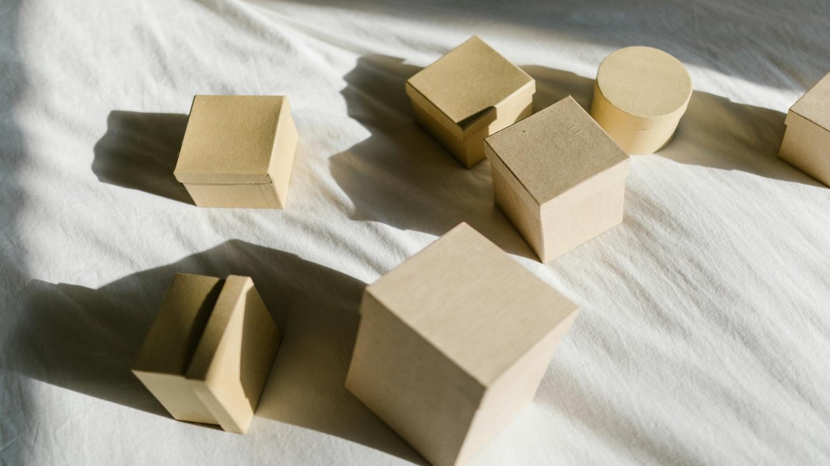 cedar wood blocks and silica gel packs placed inside a fabric storage box with clothes