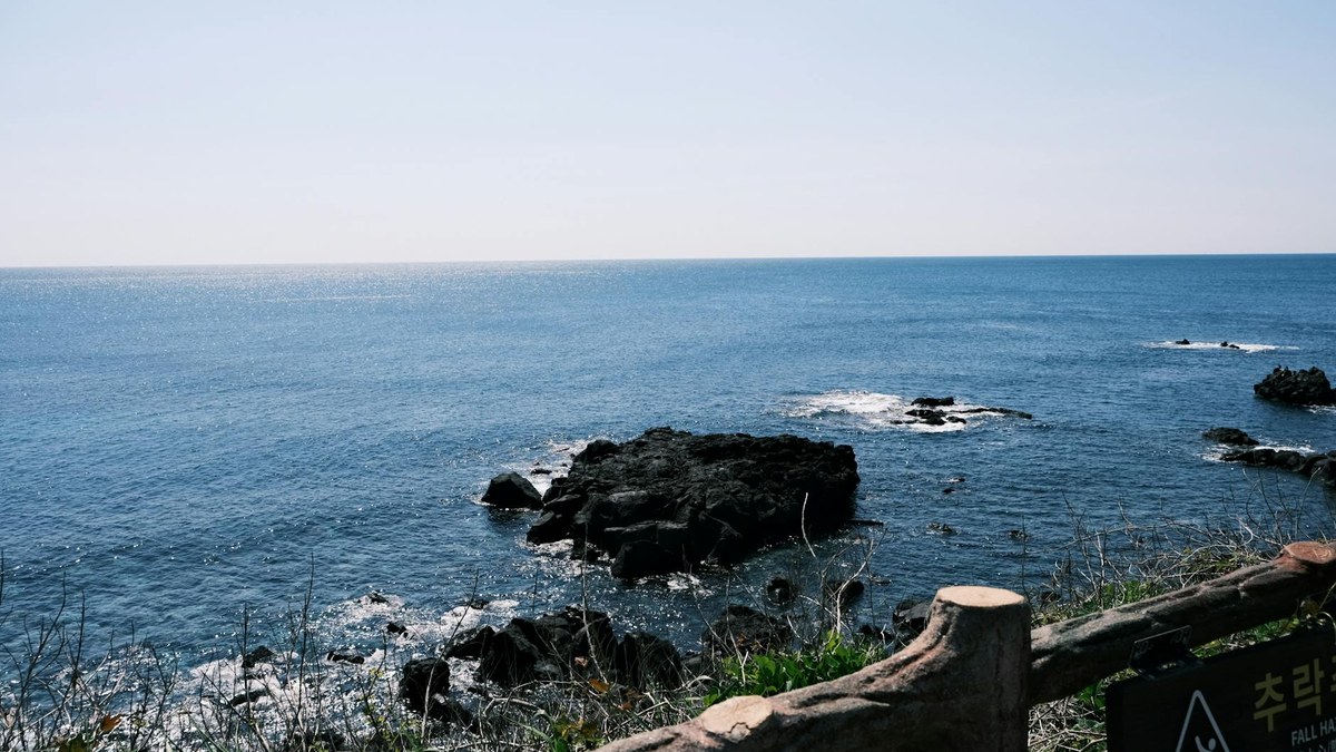 Jeju island's tranquil Woljeongri beach with colorful cafes and clear blue sky