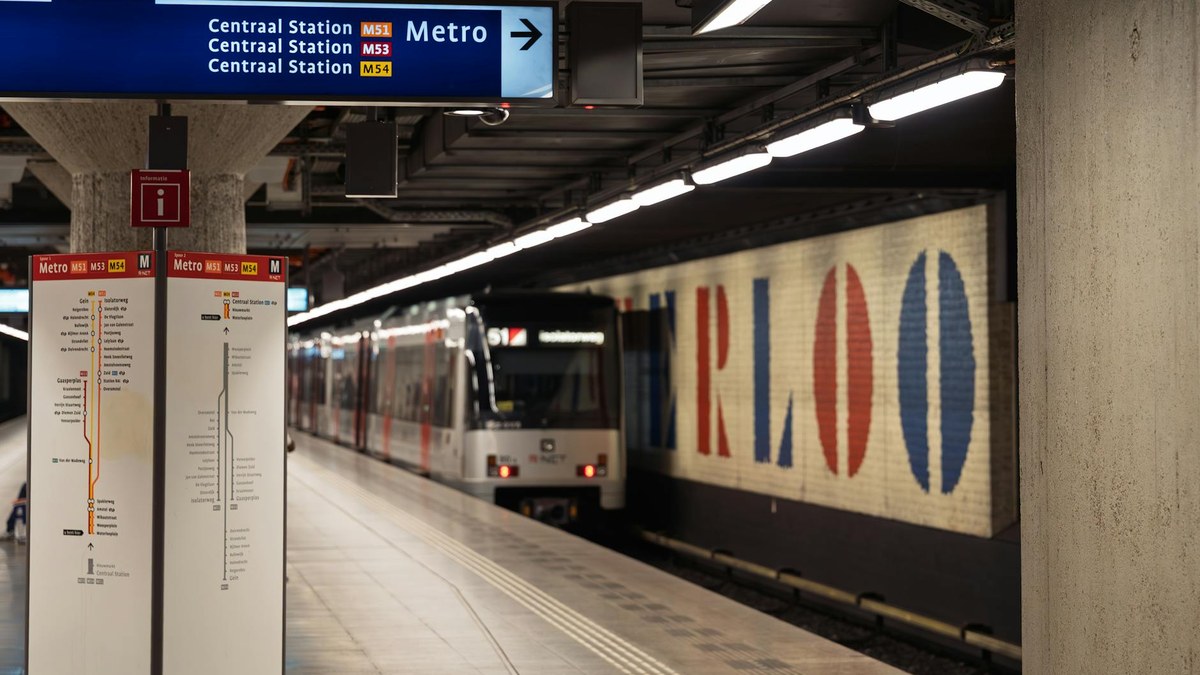woman looking at map in a train station with city skyline in background
