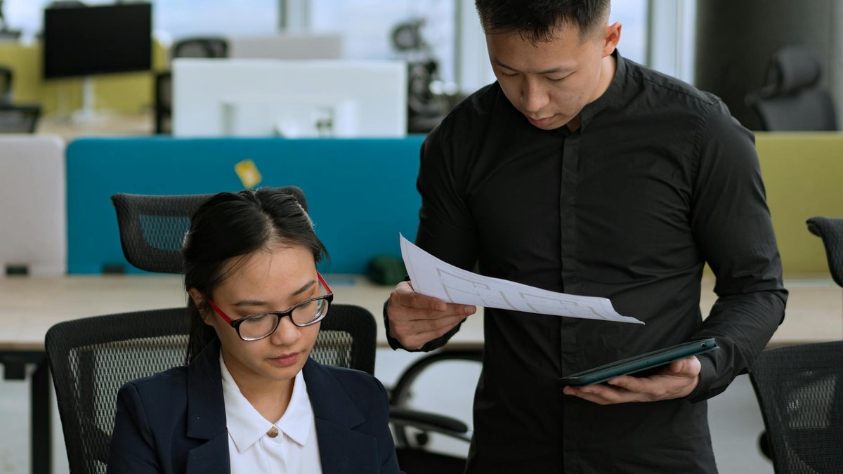 modern office worker collaborating with AI agent on a complex business strategy diagram