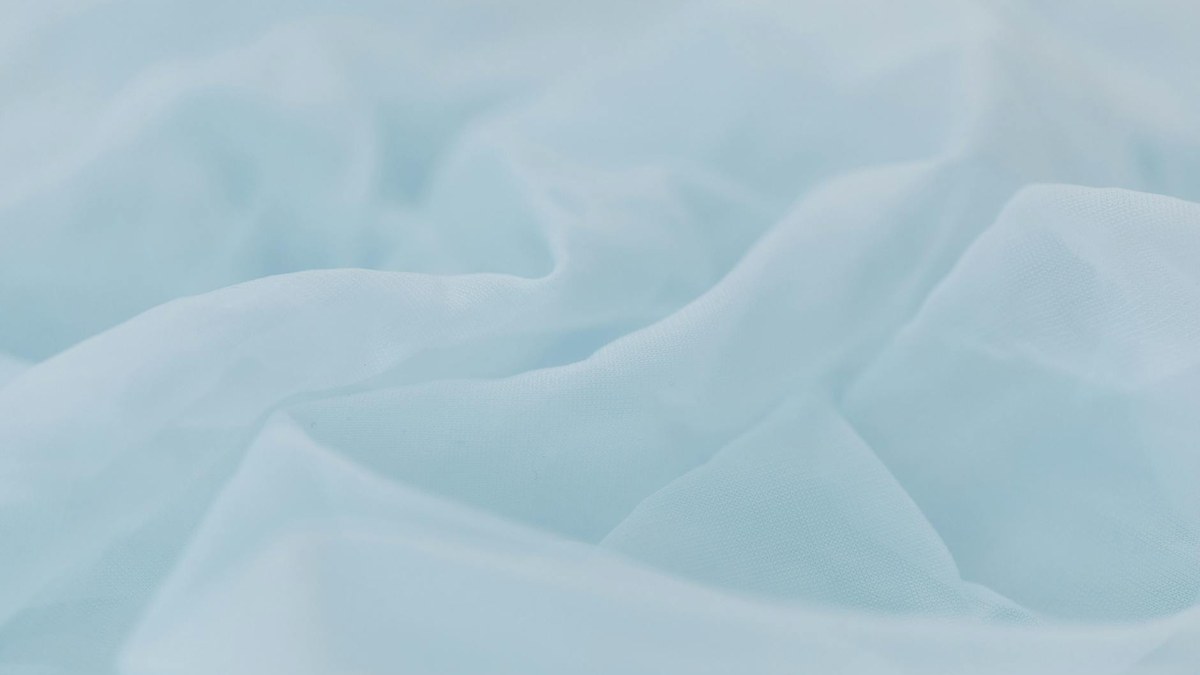 close-up shot of pastel colored fabric swatches: peach, sky blue, lavender