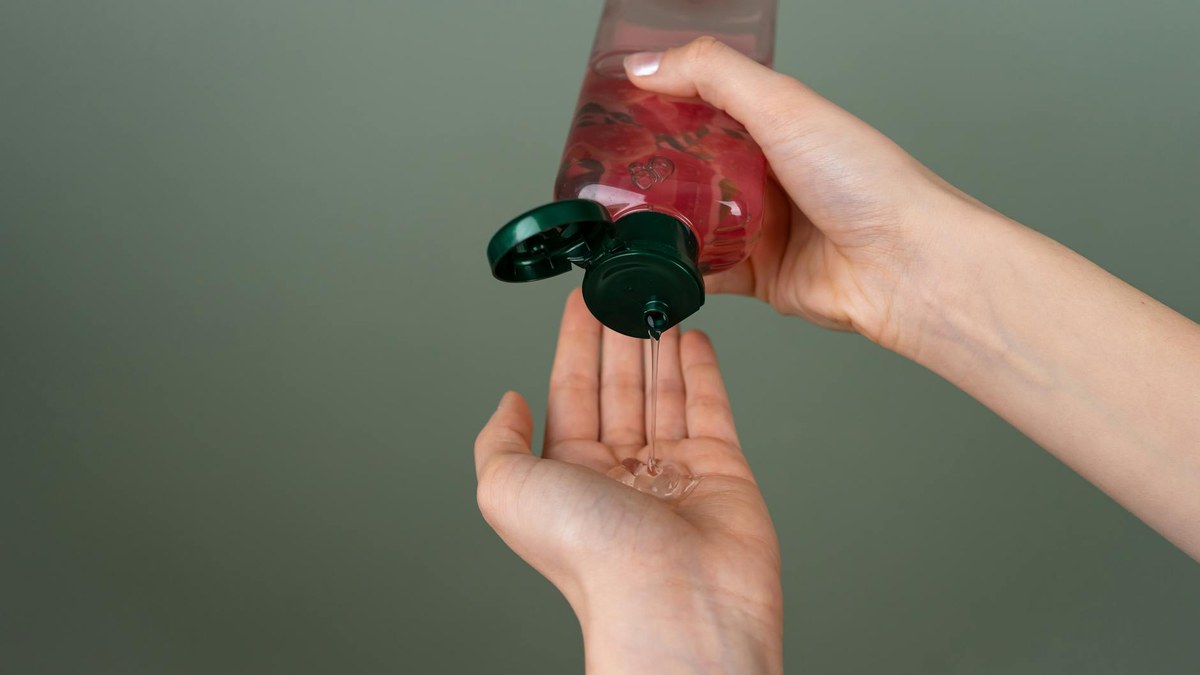 Close-up of a hand holding a clear, light-textured gel moisturizer, ready to be applied